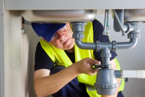 Plumber providing Houston commercial plumbing services on drain