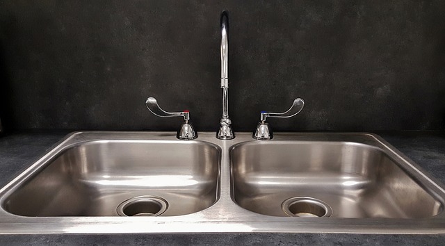 stainless steel kitchen sink installed in apartment by multifamily plumbing contractor